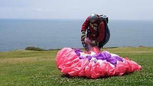 Parasailer gathering his chute